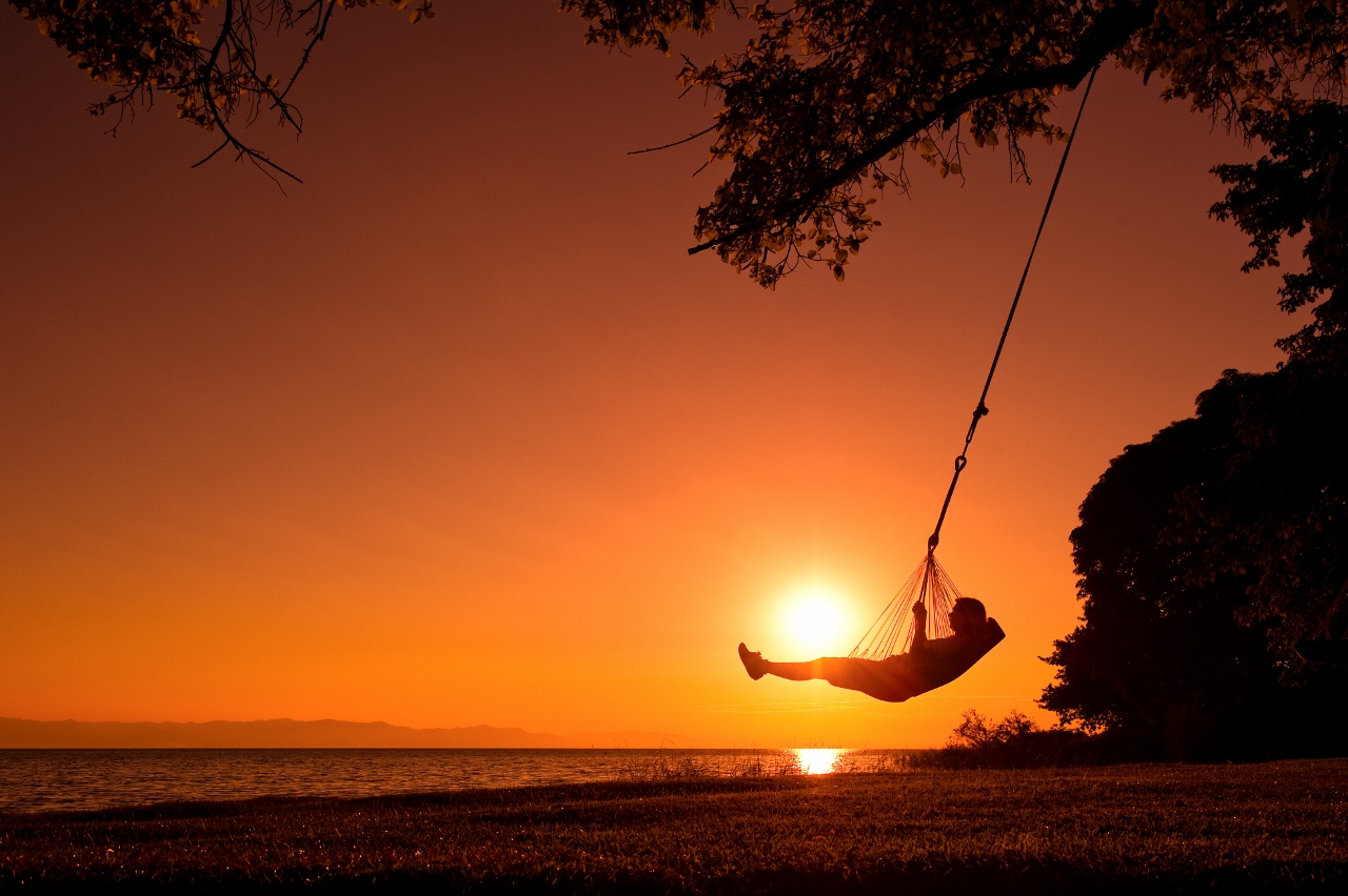 Beach swing at sunset, Pumulani, Lake Malawi