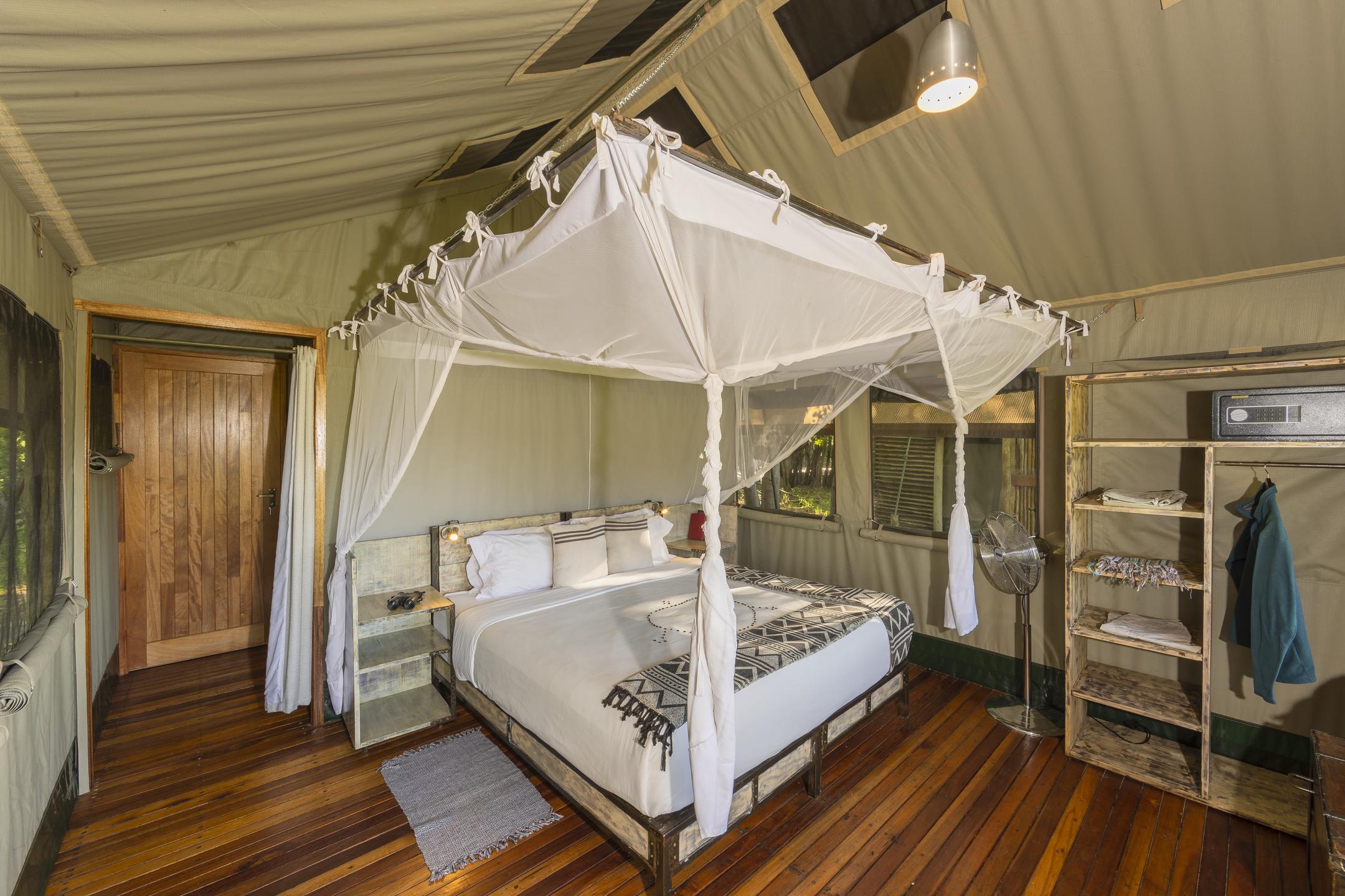 Bed inside tent at sango safari camp